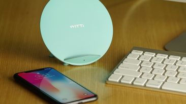 tiffany blue candy wireless charging station on desk next to phone