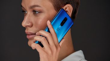 Person with Nebula Blue OnePlus 7 Pro smartphone