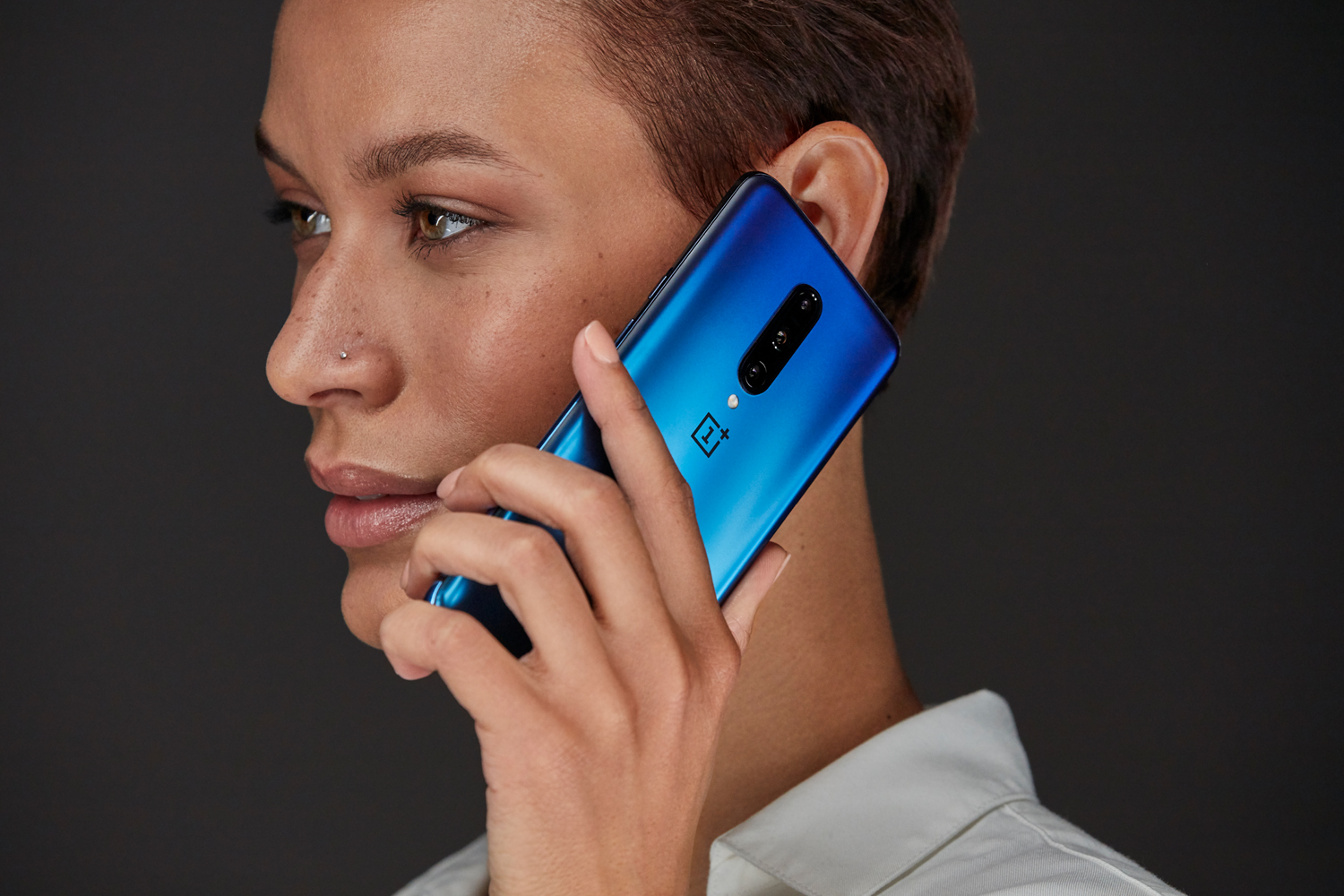 Person with Nebula Blue OnePlus 7 Pro smartphone